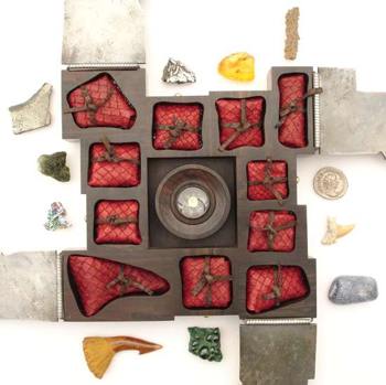 Open case of curiosities showing un-wrapped curious objects.